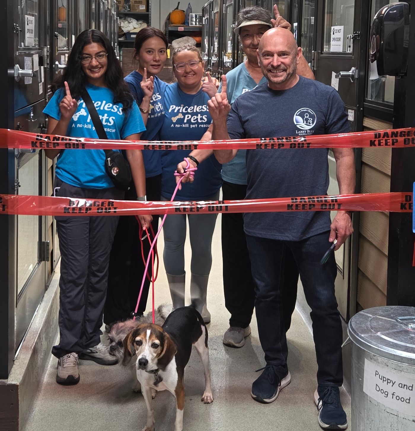 Larry Blue Foundation and Priceless Pets volunteers celebrate the completed kennel rebuild